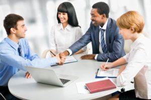 group of business people gathered around a table - https://sclequipmentfinance.com/