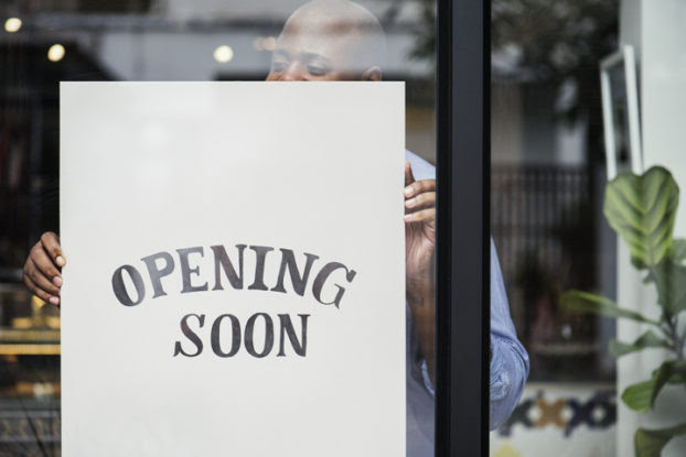 Opening Soon sign in shop window